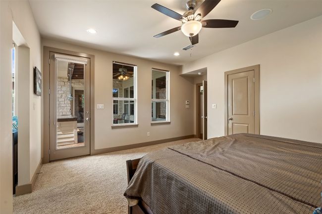 Bedroom with light colored carpet, baseboards, access to exterior, recessed lighting, and ceiling fan | Image 19
