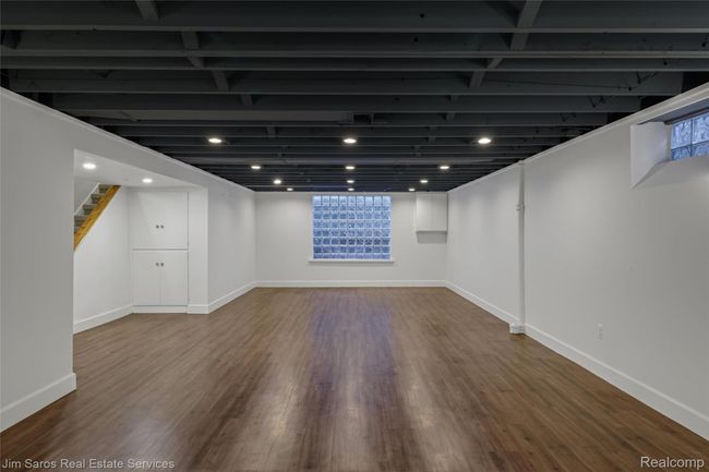 Basement with stairway, dark wood finished floors, and recessed lighting | Image 31