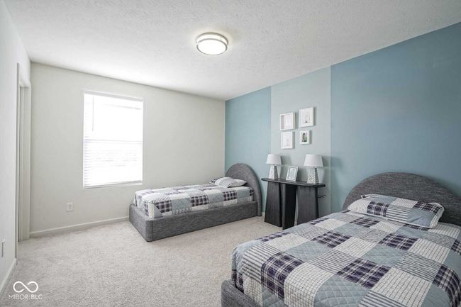 carpeted bedroom with baseboards and a textured ceiling | Image 27