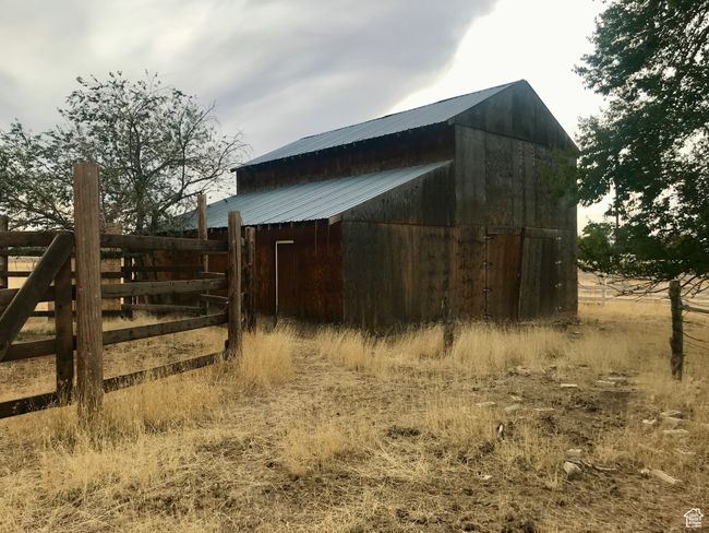 View of barn featuring fence and a round coral | Image 70
