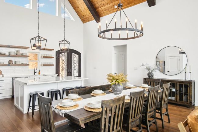 Dining area featuring a chandelier, high vaulted ceiling, a wood ceiling with exposed beams, and dark wood finished floors | Image 11