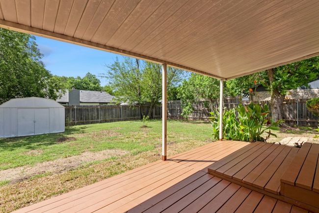 Wooden terrace with a fenced backyard and a storage shed | Image 25