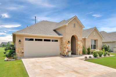 View of front of home with a garage and beautiful landscaping | Image 2