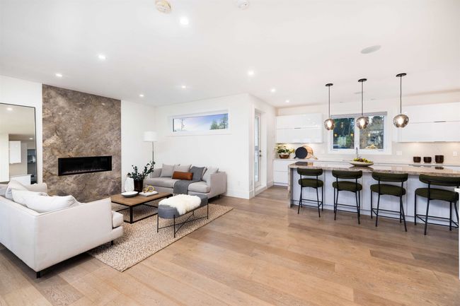 Living area with recessed lighting, light wood-style floors, and a high end fireplace | Image 5