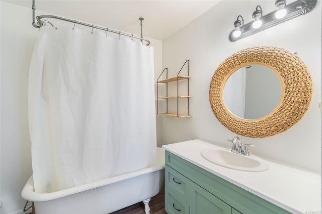 Full bath with vanity, shower / tub combo with curtain, and wood finished floors | Image 52