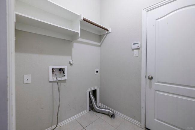 Laundry area with electric dryer hookup, light tile patterned floors, hookup for a washing machine, and gas dryer hookup | Image 27