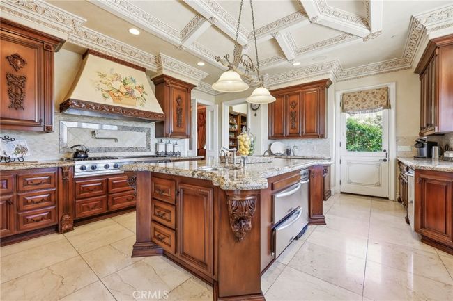 The kitchen is perfectly laid out with large center island. | Image 21