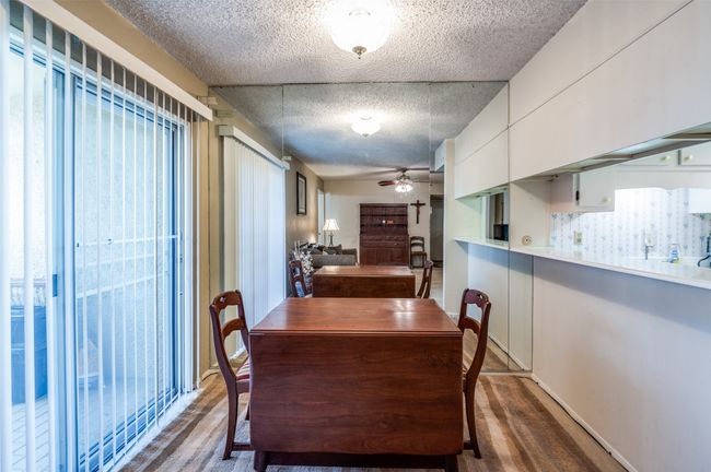Dining space featuring ceiling fan, a textured ceiling, and wood finished floors | Image 13