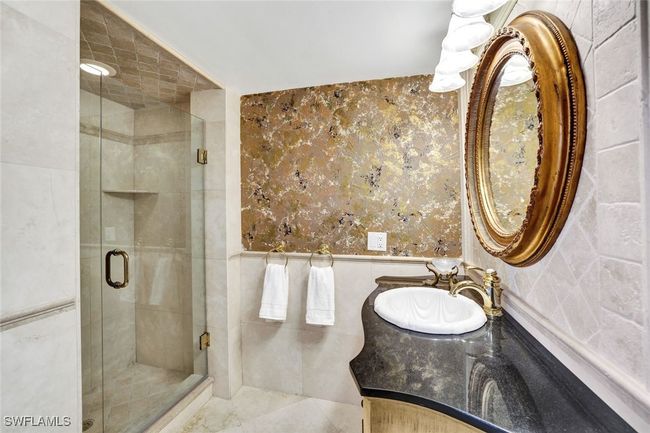 Full bath with a shower stall, tile walls, and vanity | Image 12