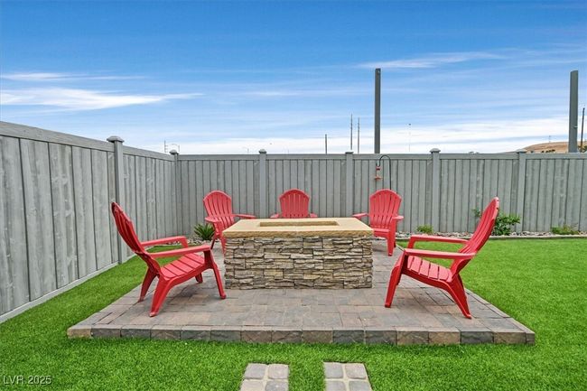View of patio with a fenced backyard and an outdoor fire pit | Image 26