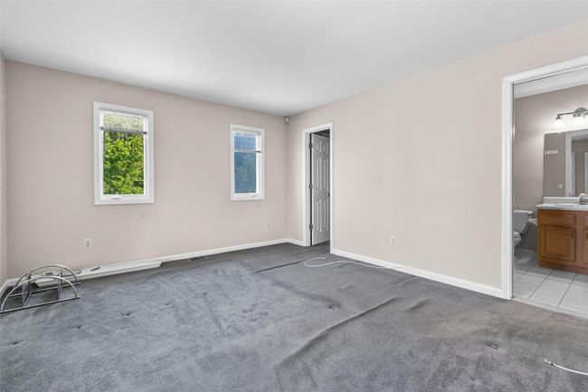 Unfurnished bedroom featuring a sink, carpet, baseboards, and ensuite bath | Image 21