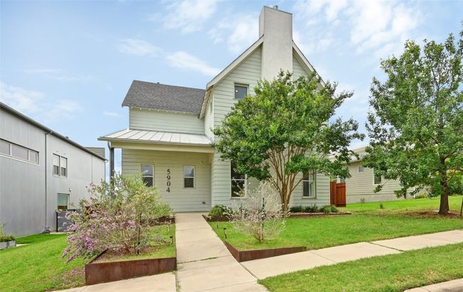 View of front facade featuring a standing seam roof, a front lawn, a metal roof, and a chimney | Image 28