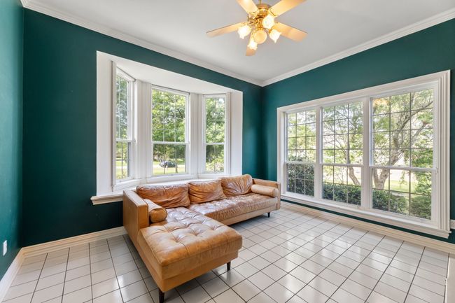 Living area featuring ceiling fan and crown molding | Image 8