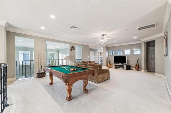 Conveniently located near all of the secondary bedrooms, the gameroom will be the center hub of your upstairs. Measuring 36' x 17', this Gameroom is large enough to accommodate whatever set up you'd like. Upgraded wrought iron spindles are found throughout the 2nd floor opening to the 1st floor. | Image 25