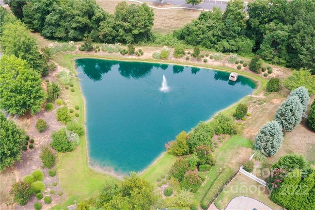Community pond with sidewalks and park benches | Image 30