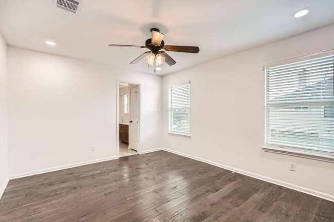 Empty room featuring ceiling fan, dark wood-type flooring, baseboards, and recessed lighting | Image 17