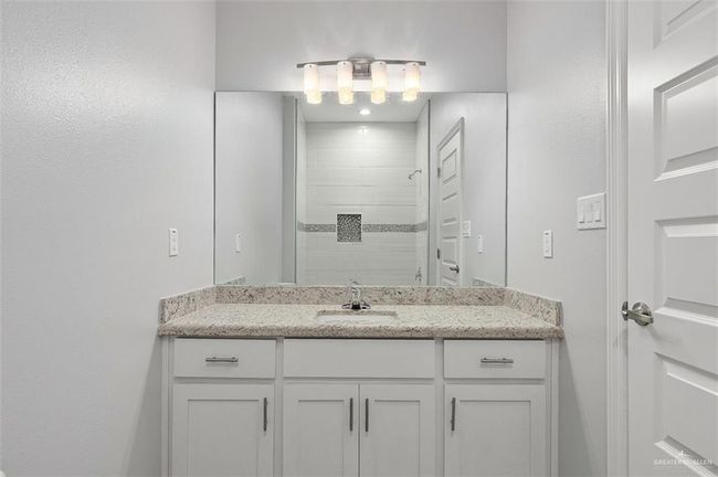 Bathroom featuring a tile shower and vanity | Image 5