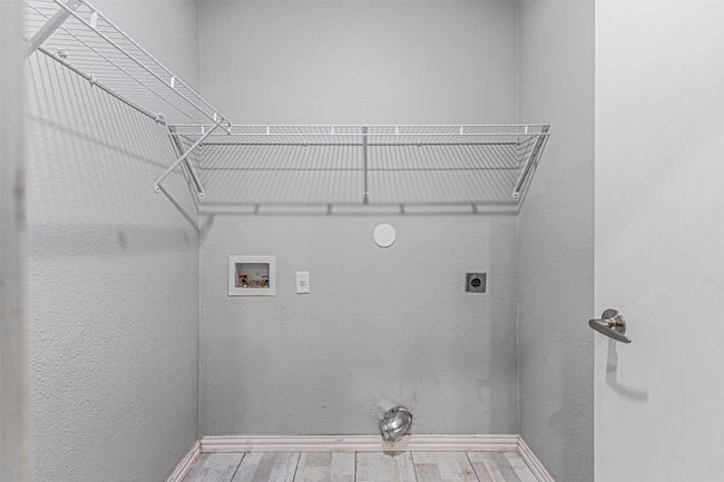 Washroom featuring electric dryer hookup, hookup for a washing machine, and wood finished floors | Image 20
