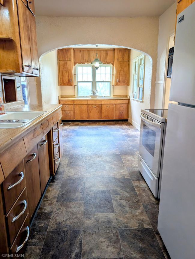 Galley kitchen and breakfast nook with storage | Image 11
