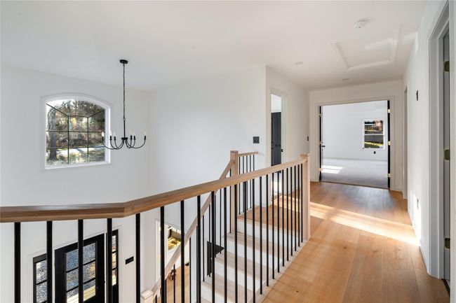 Hallway featuring an upstairs landing, a chandelier, and light wood finished floors | Image 37