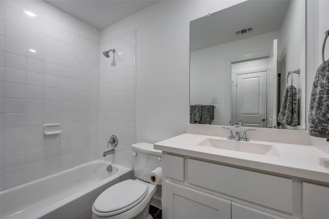 Full bath with visible vents, toilet, vanity, and tub / shower combination | Image 26