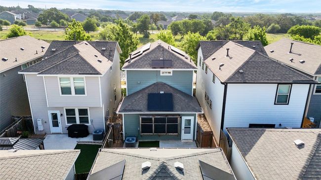 Back of house with a patio area, central air condition unit, a residential view, and a fenced backyard | Image 22