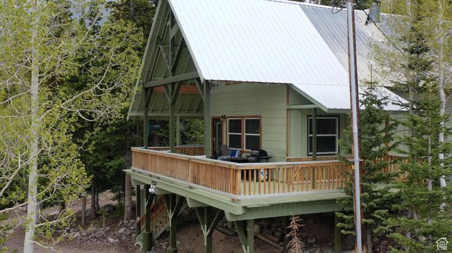 Back of property with a metal roof and a wooden deck | Image 54
