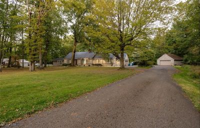 View of front of property with an outbuilding, a garage, and a front yard | Image 1