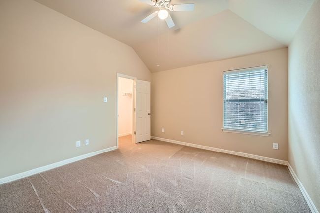Spare room with a ceiling fan, vaulted ceiling, and carpet flooring | Image 22