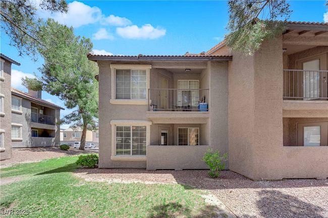 Back of property featuring stucco siding, a balcony, and a tiled roof | Image 15