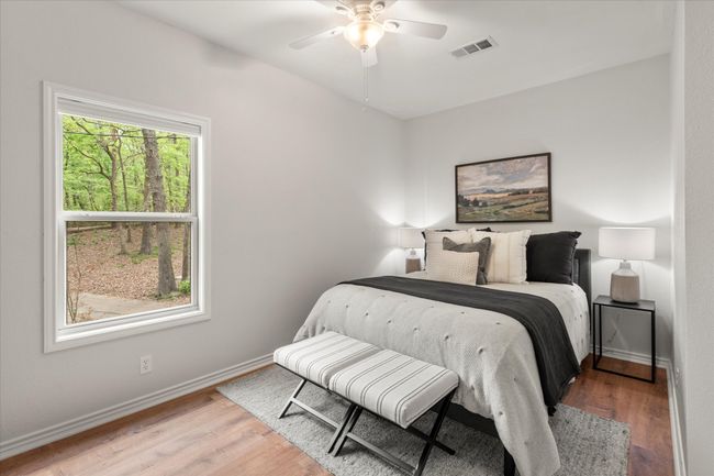Bedroom featuring light wood-style floors, visible vents, a ceiling fan, and baseboards | Image 31