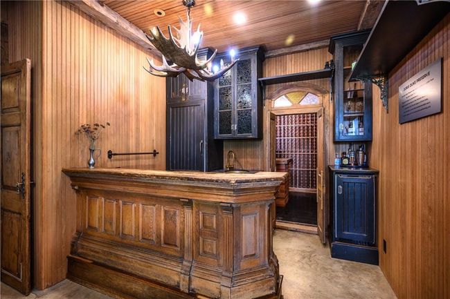 Bar with wood walls, sink, and wood ceiling | Image 8