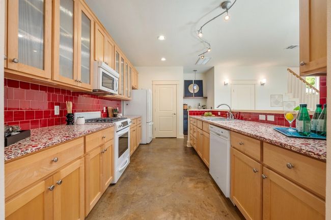 The kitchen’s great layout maximizes both space and efficiency, with plenty of counter room and smart storage solutions that make cooking and entertaining a breeze | Image 15