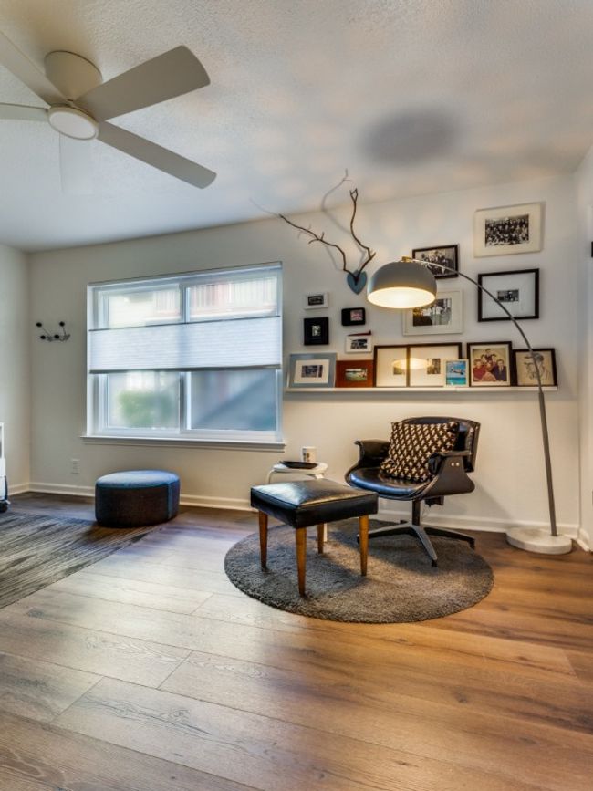 Living area featuring plenty of natural light, wood finished floors, ceiling fan, a textured ceiling, and baseboards | Image 7