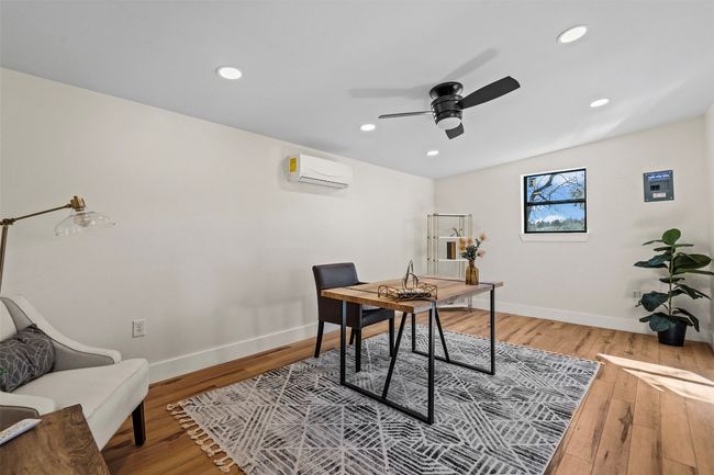 Office area with ceiling fan, an AC wall unit, hardwood / wood-style flooring, baseboards, and recessed lighting | Image 27