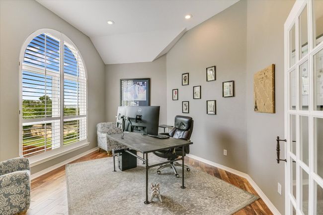 Office area with vaulted ceiling, wood finished floors, baseboards, and recessed lighting | Image 10