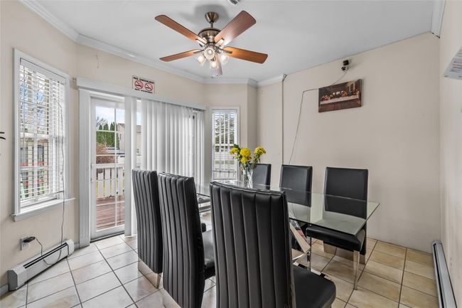 Dining area featuring a baseboard radiator, a baseboard heating unit, crown molding, and a ceiling fan | Image 7