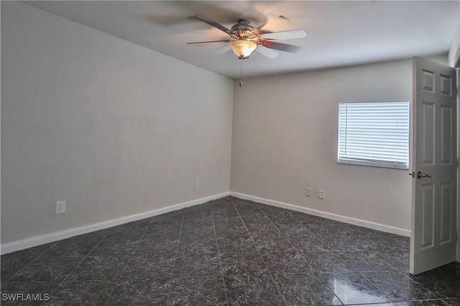 Spare room featuring a ceiling fan and baseboards | Image 9