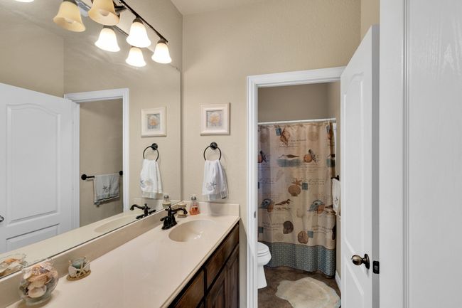 Full bathroom featuring toilet, vanity, and a shower with shower curtain | Image 17