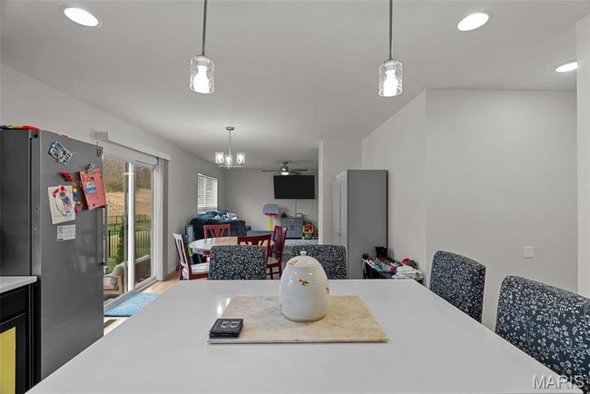 Kitchen featuring refrigerator, dishwashing machine, stove, a sink, and dark cabinetry | Image 30