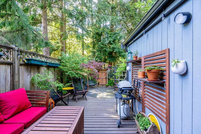 Wooden terrace with a fenced backyard | Image 22