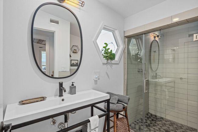 Bathroom with a shower stall and a sink | Image 18