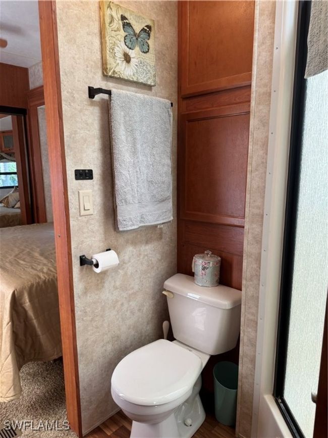 Bathroom featuring wood-type flooring and toilet | Image 20