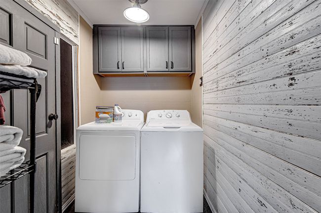 Secondary house- full laundry room with cabinet storage | Image 34