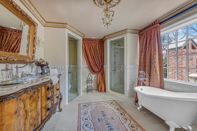 Full bathroom with plenty of natural light, independent shower and bath, tile patterned flooring, and tile walls | Image 17