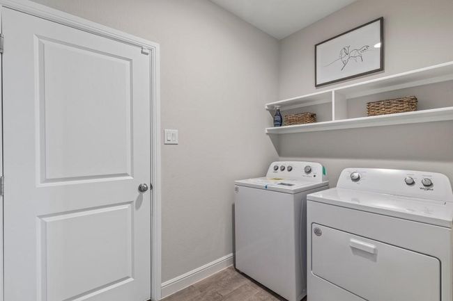 Washroom featuring independent washer and dryer and wood finished floors | Image 25