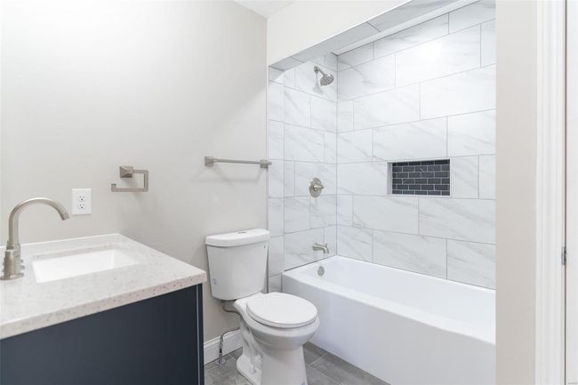 Full bathroom with toilet, vanity, and tiled shower / bath combo | Image 25