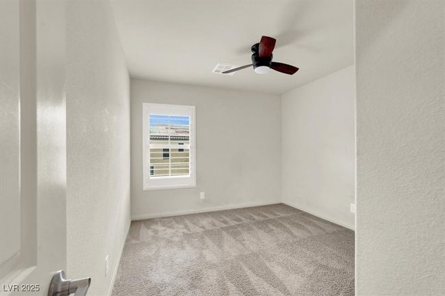 Empty room featuring carpet floors, a ceiling fan, and a textured wall | Image 46