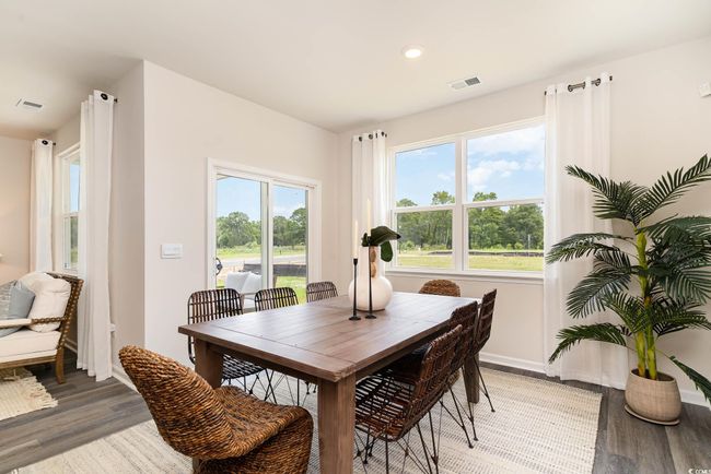 Dining area with light wood-style floors, visible vents, and baseboards | Image 8