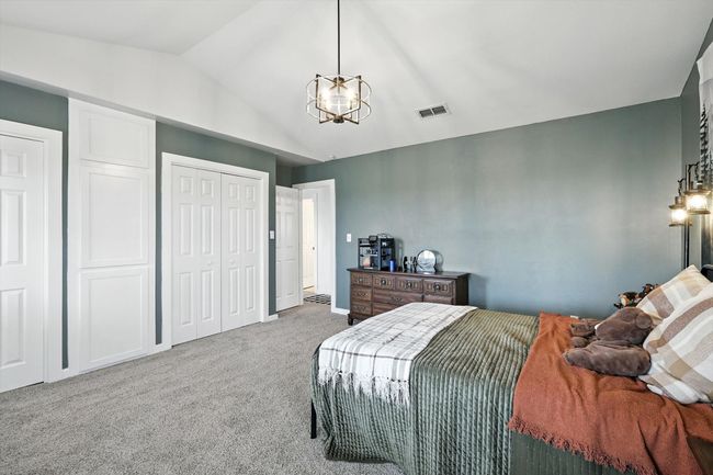 Bedroom featuring lofted ceiling, carpet, a closet, and a chandelier | Image 30